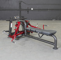 Thumbnail for Red and black lying pec fly machine with a padded bench in a gym setting.