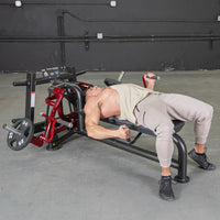 Thumbnail for Man lying on a red and black pec fly machine, performing a chest fly exercise.