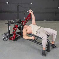 Thumbnail for Man using a red and black lying pec fly machine with a 25lb weight plate.