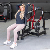 Thumbnail for Woman using a red and black overhead triceps extension machine with a 10lb weight plate.