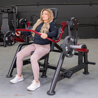 Thumbnail for Woman with blonde hair using a black and red Power Leverage V2 Pullover machine with 25lb weights.