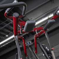 Thumbnail for Red Viking press/calf machine with black padded rests and handles in a gym.