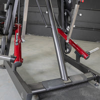 Thumbnail for Close-up of the base and red leverage arms of a Viking press machine with weight plates.
