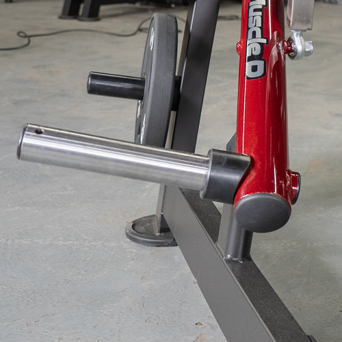 Close-up of a silver weight plate sleeve on a red and black Viking press machine.
