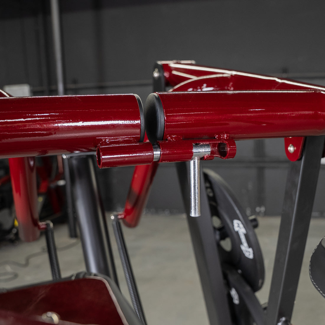 Close-up of the red Viking Press machine's adjustable pin mechanism.