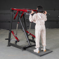 Thumbnail for Woman using a red and black Viking press machine for a calf raise or shoulder press.