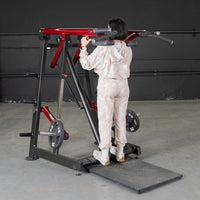 Thumbnail for Woman using a red and black Viking press / calf machine with weight plates in a gym.