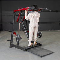 Thumbnail for Woman using a red and black Viking press / calf raise machine with weight plates.