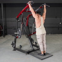 Thumbnail for Man using a red and black Viking press / calf raise machine with weight plates in a gym.
