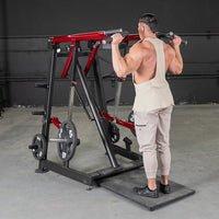 Thumbnail for Man using a red and black Viking press machine with weight plates in a gym.