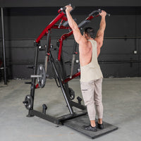 Thumbnail for Man using a red and black Viking press machine with weights in a gym.