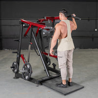 Thumbnail for Man using a red and black Viking press machine with weight plates in a gym.