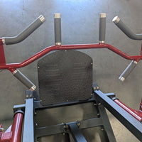 Thumbnail for Close-up of a red and black linear bearing row machine with multiple grip handles and a diamond plate footrest.