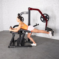 Thumbnail for Woman using a black and red plate-loaded glute kickback machine.
