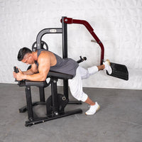 Thumbnail for Man using a black and red glute kickback machine, pushing a footplate with his right leg.