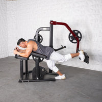 Thumbnail for Man using a plate-loaded glute kickback machine, lying prone on the bench and extending his leg.