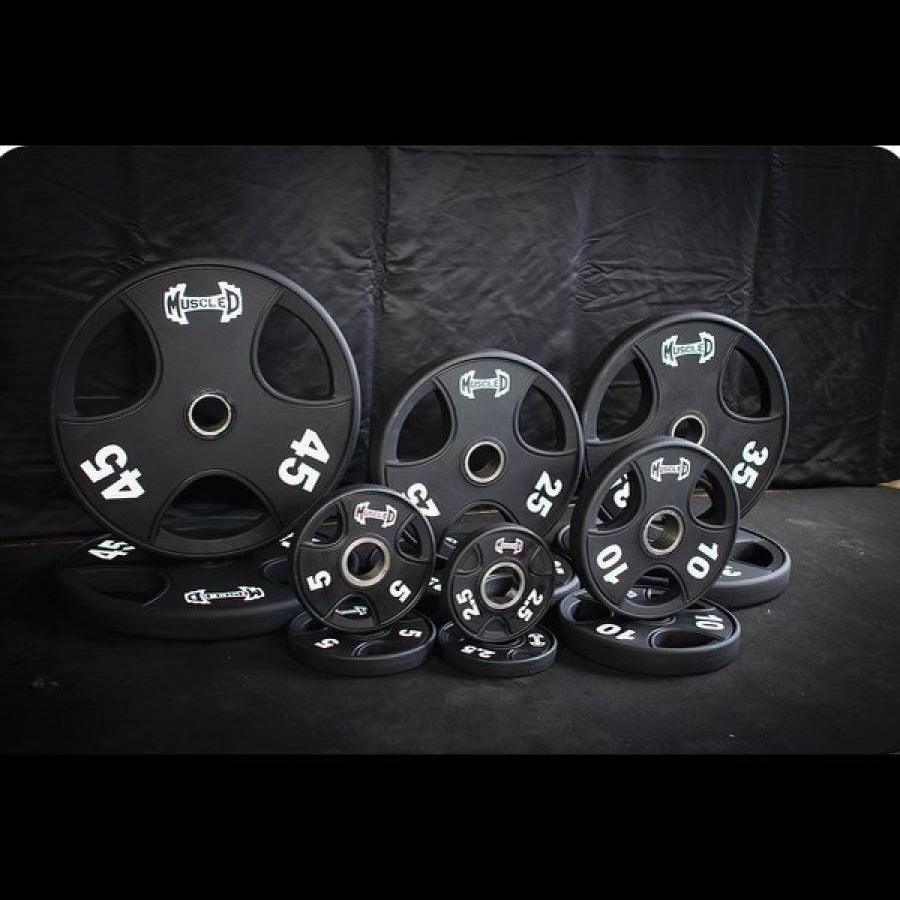 Black urethane-coated Olympic weight plates in various sizes (45, 35, 25, 10, 5, 2.5 lbs).