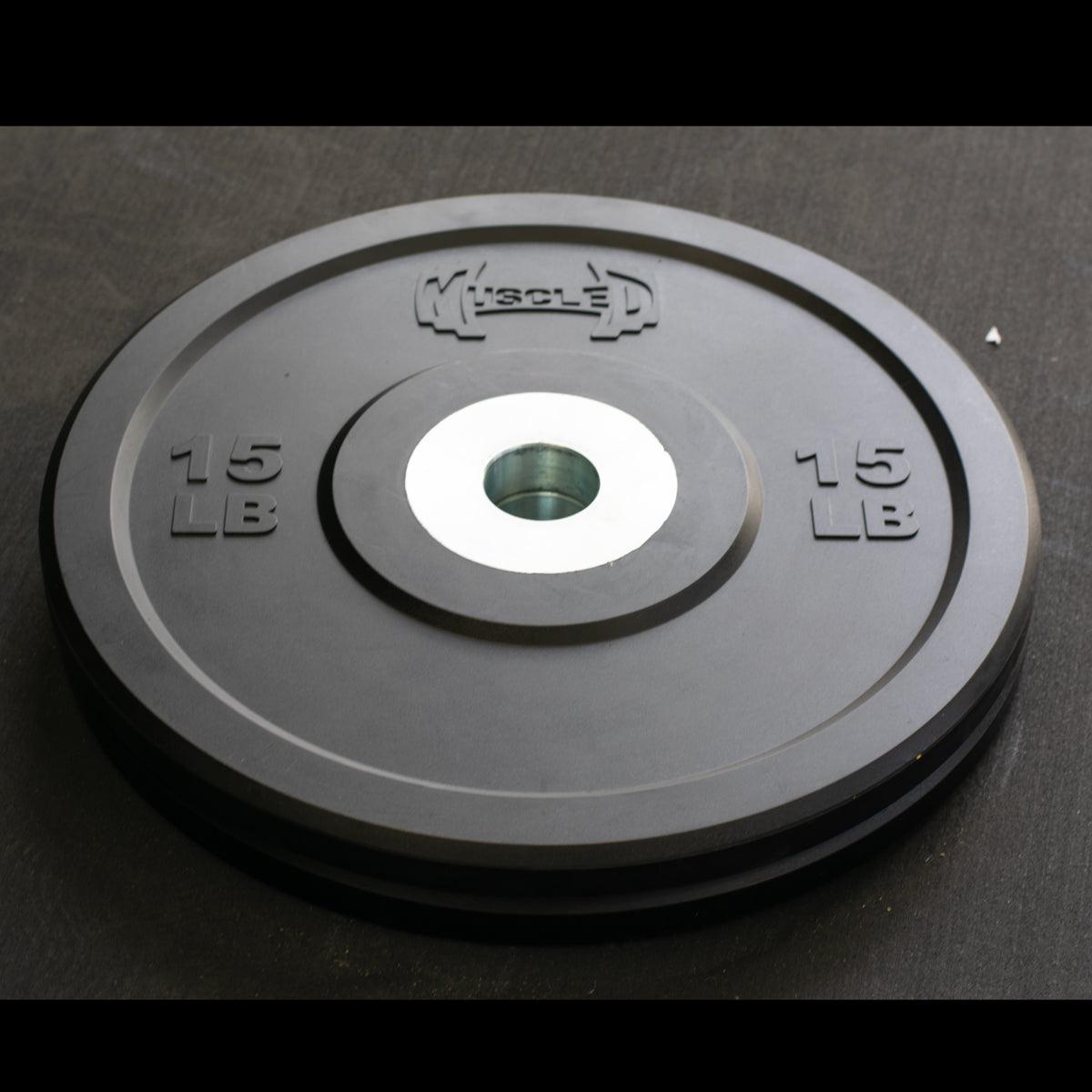 Black 15 lb bumper plate with "MUSCLE D" logo and steel hub.