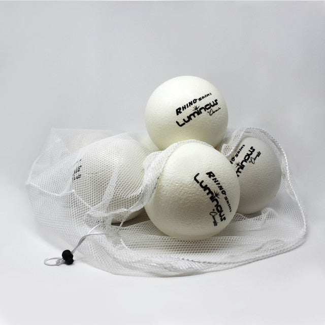 Four white foam dodgeballs with "Rhino Skin Luminous" logo in a white mesh bag.