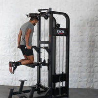 Thumbnail for Man performing dips on a black Excel assisted chin/dip combo machine with a white textured wall background.