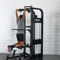 Thumbnail for Man performing assisted chin-up on a black Excel chin/dip combo machine with adjustable knee pad.