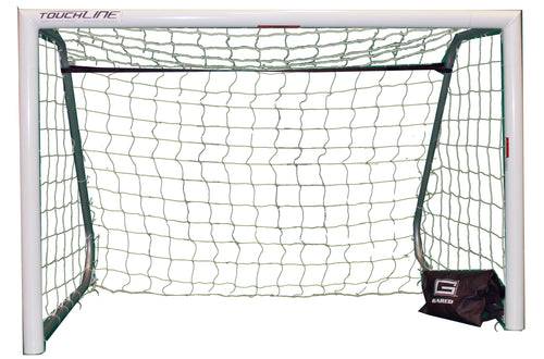 White recreational soccer goal with green net and black weight bag.