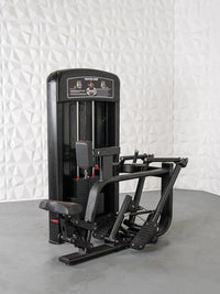 Thumbnail for Black seated row machine with weight stack, seat, footrests, and handles on a gray floor.