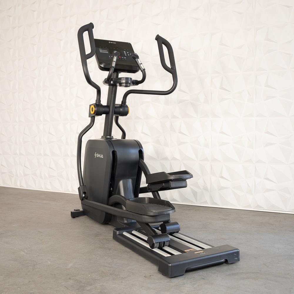 Black commercial cross trainer elliptical with a digital display and moving handlebars.