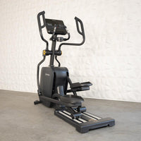 Thumbnail for Black commercial cross trainer elliptical with a digital display and moving handlebars.