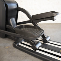 Thumbnail for Close-up of the foot pedals and track of a black commercial cross trainer elliptical.