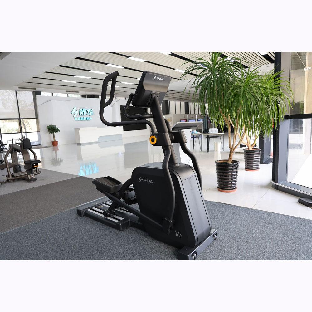 Black commercial cross trainer elliptical in a modern gym setting.