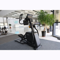 Thumbnail for Black commercial cross trainer elliptical in a modern gym setting.