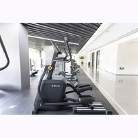 Thumbnail for Black commercial cross trainer elliptical in a modern gym setting.
