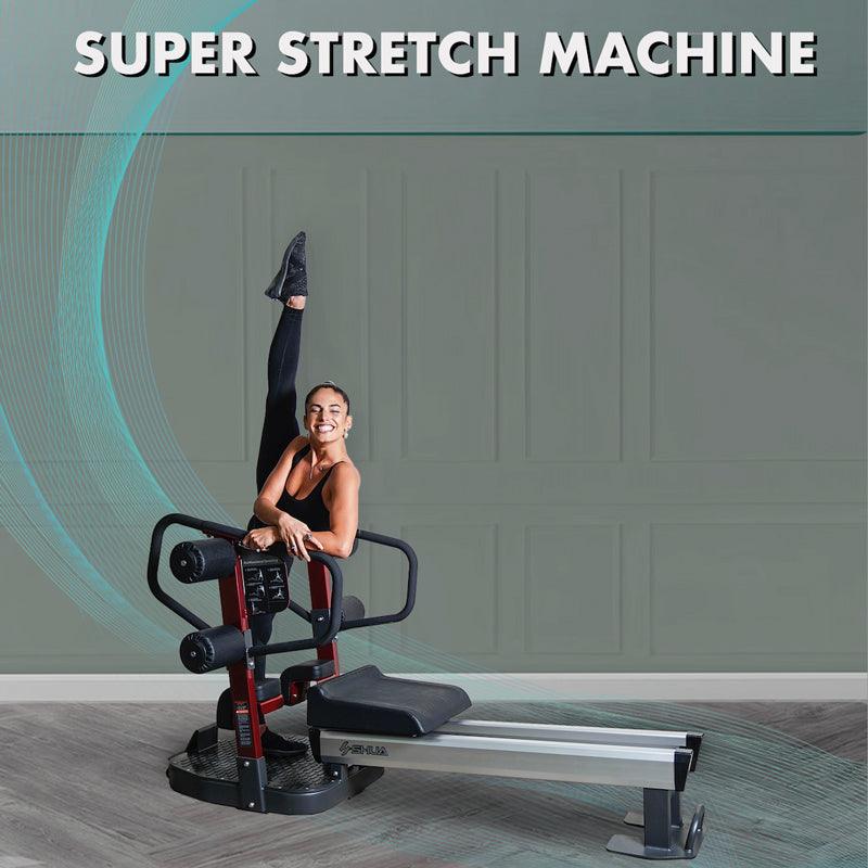 Woman in black activewear stretching one leg high on a red and black stretching machine.
