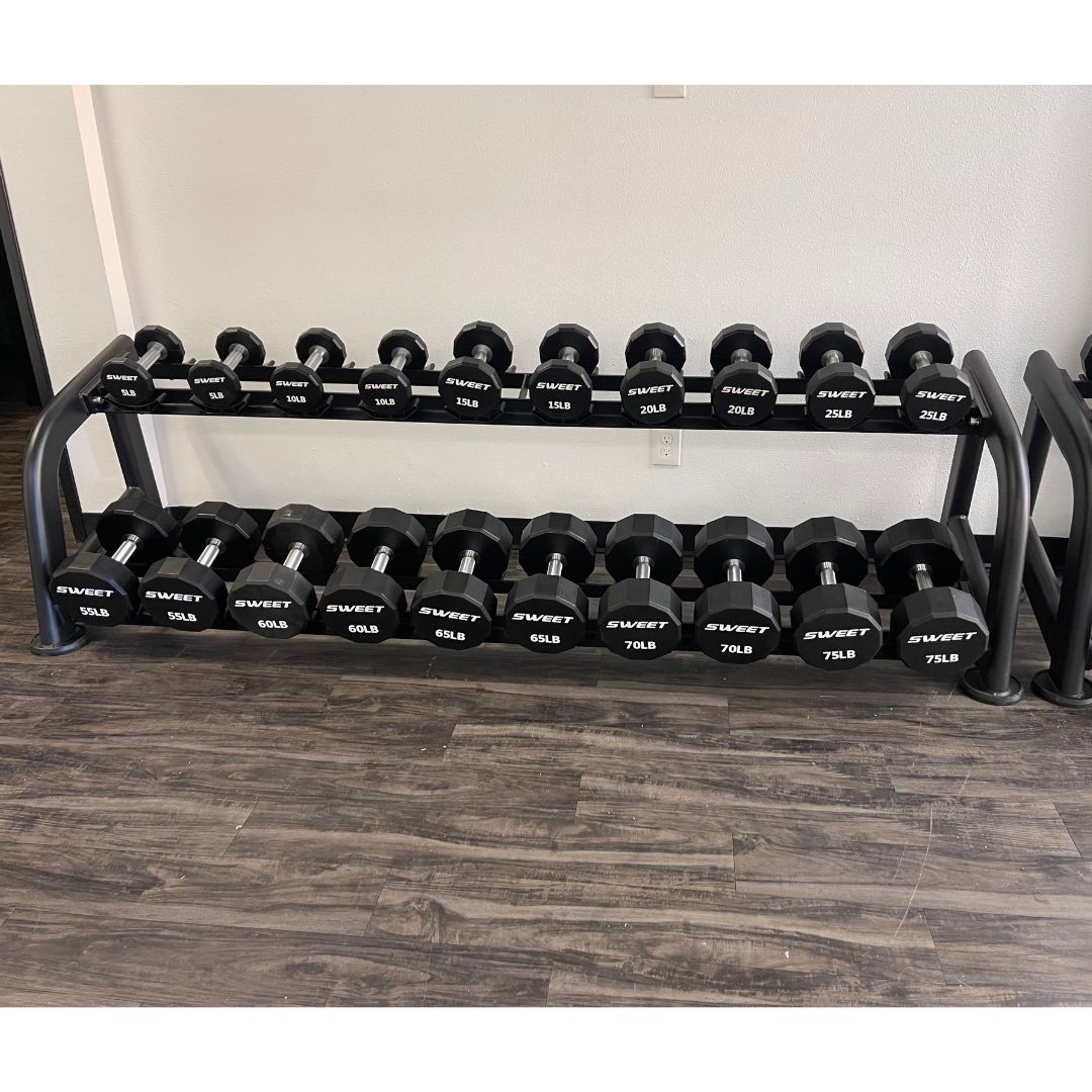 Black dumbbells with "SWEET" logo on a two-tier rack, ranging from 5lb to 75lb.