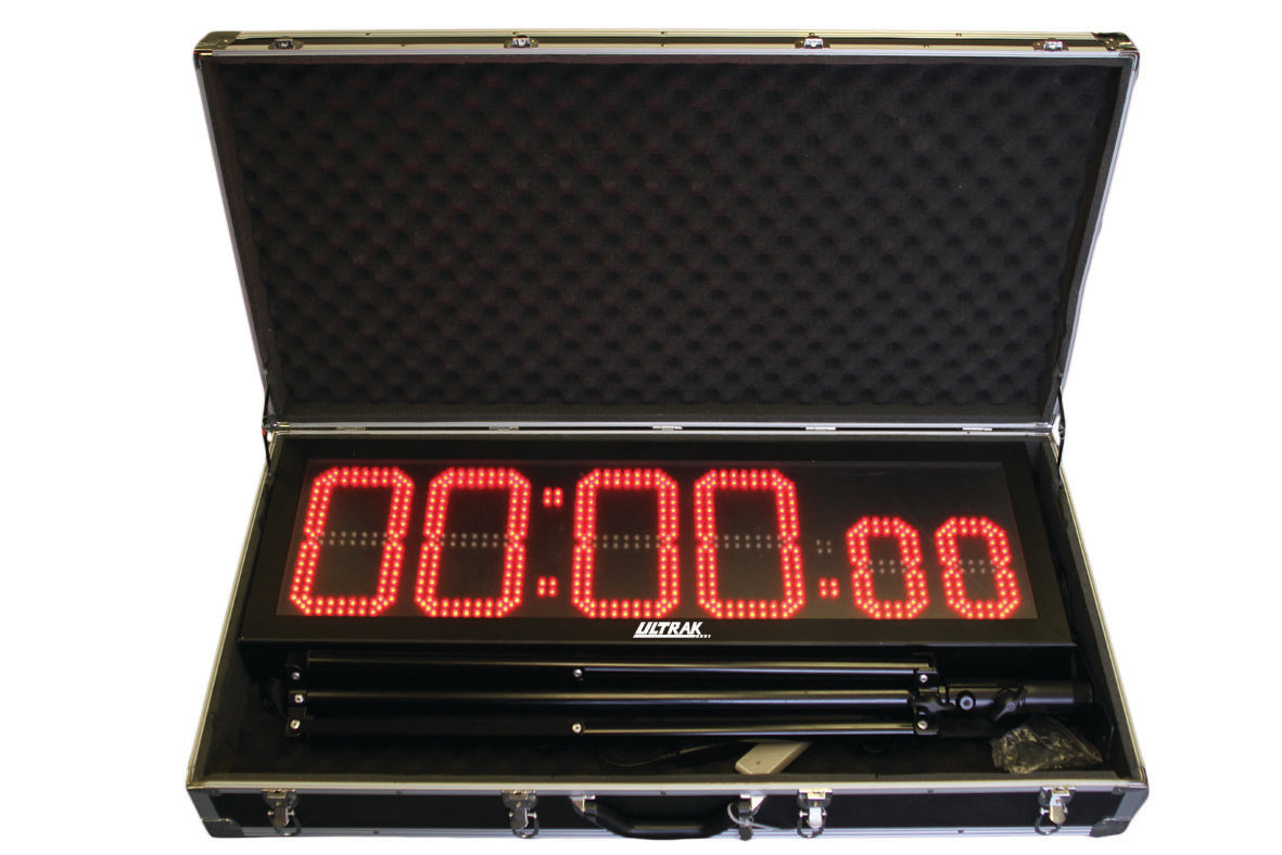 LED display timer with tripod in an open black carrying case.
