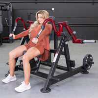 Thumbnail for Woman using a red and black triceps extension machine with a 25lb weight plate.