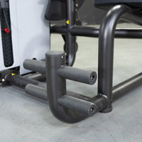 Thumbnail for Close-up of the black, padded footrests and frame of the Vogue AB/Back Combo fitness machine.
