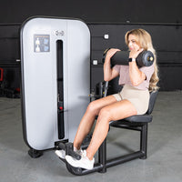 Thumbnail for Woman using a Vogue AB/Back Combo machine for abdominal workout, with weight stack visible.