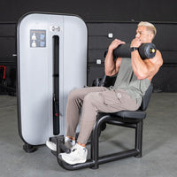 Thumbnail for Man using a gray and black ab/back combo machine for abdominal workouts.