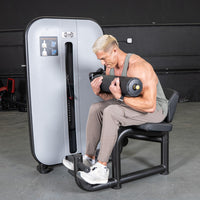 Thumbnail for Man using a gray and black ab/back combo machine for abdominal workouts.
