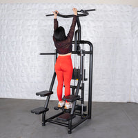 Thumbnail for Woman in red leggings using a black assisted chin/dip machine with a weight stack.