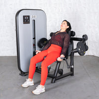 Thumbnail for Woman in red leggings using a black and gray arm curl machine.