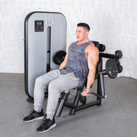 Thumbnail for Man in gray tank top and sweatpants using a black and gray arm curl machine.