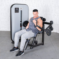 Thumbnail for Man in tank top and sweatpants using a black and gray arm curl machine.