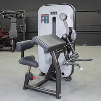 Thumbnail for Grey and black biceps/triceps combo gym machine with padded seat and armrests.