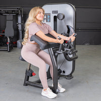 Thumbnail for Woman using a biceps curl machine in a gym.