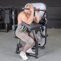 Thumbnail for Man using a bicep curl machine in a gym.