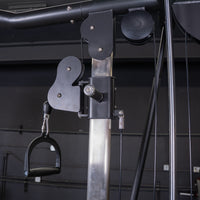 Thumbnail for Close-up of a cable crossover machine with a black handle attached to a pulley system.