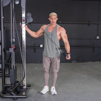 Thumbnail for Man in tank top and cargo pants using a cable crossover machine.